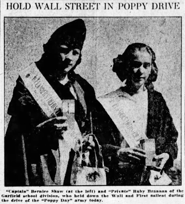 “HOLD WALL STREET IN POPPY DRIVE” – The Spokane Chronicle, 29 May 1920: page 3. “Captain” Bernice Shaw (at the left) and “Private” Ruby Brannan of the Garfield school division, who held down the Wall and First salient during the drive of the “Poppy Day” army today.” 